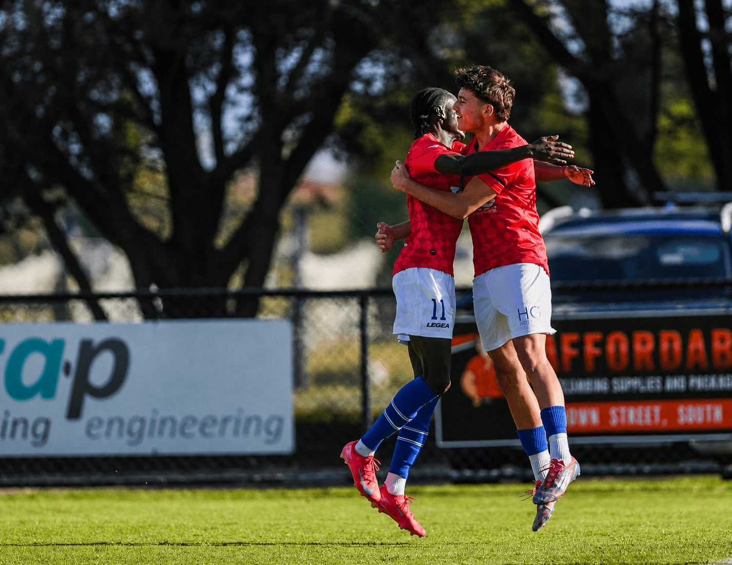 Aguer celebrating with a teammate after a football match